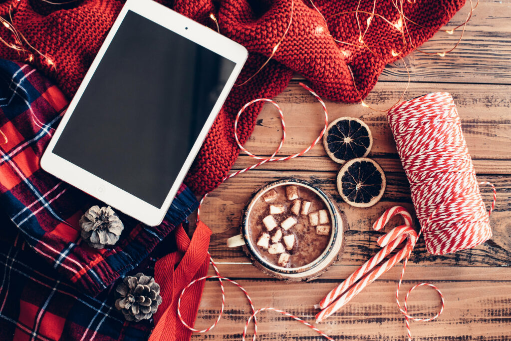 iPad on table with Christmas decorations.