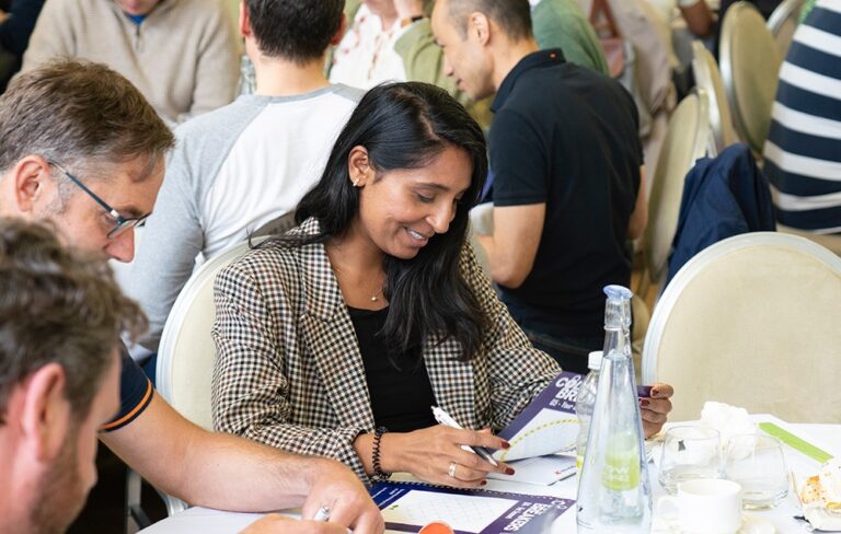 Woman smiling at puzzle