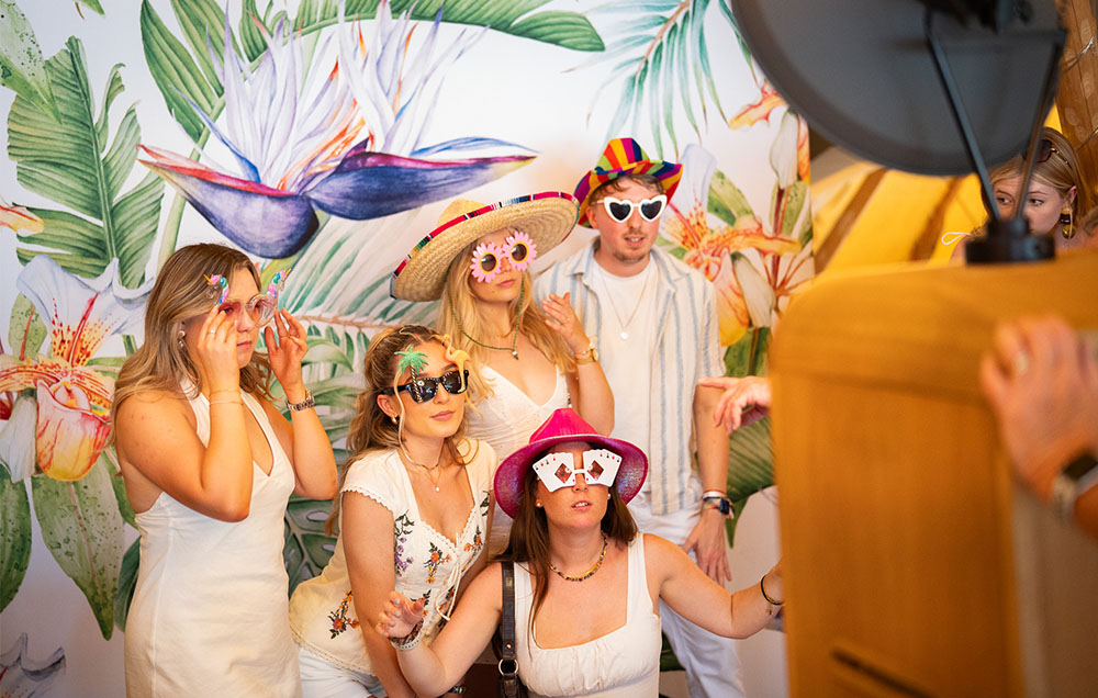 Women in a photo booth posing.