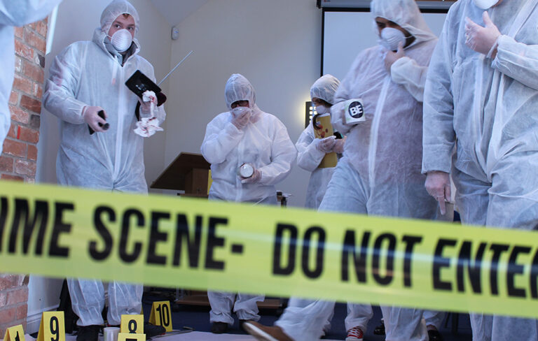 People stood around fake crime scene