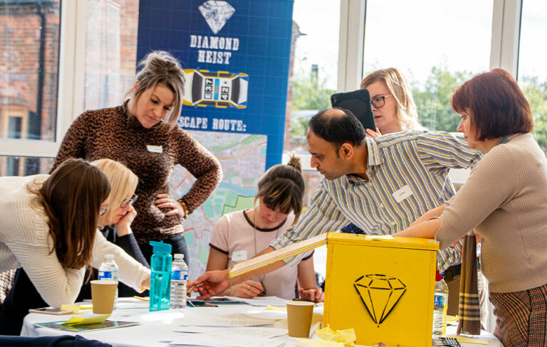 People solving table top puzzle