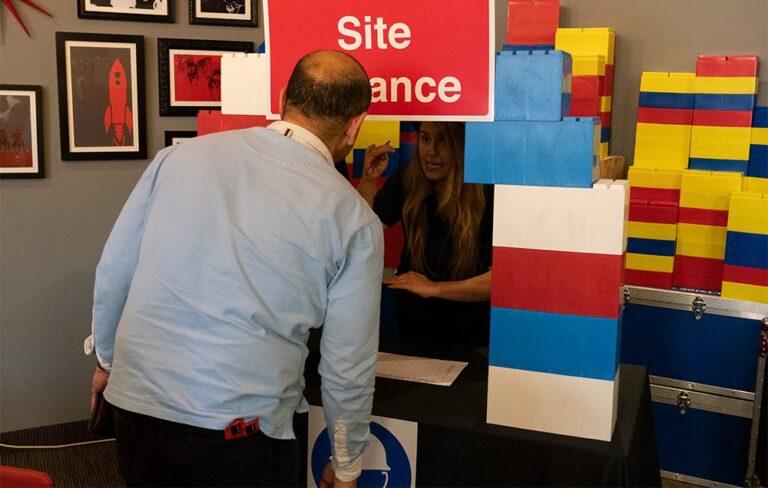 Person looking into colourful brick den