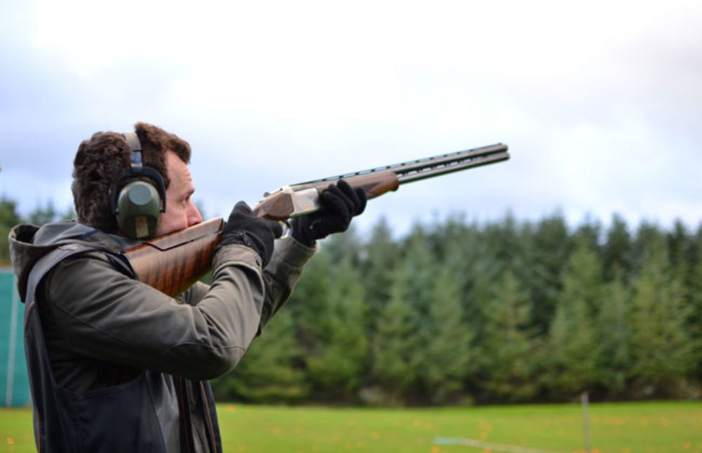 Man taking part in clay pigeon shooting