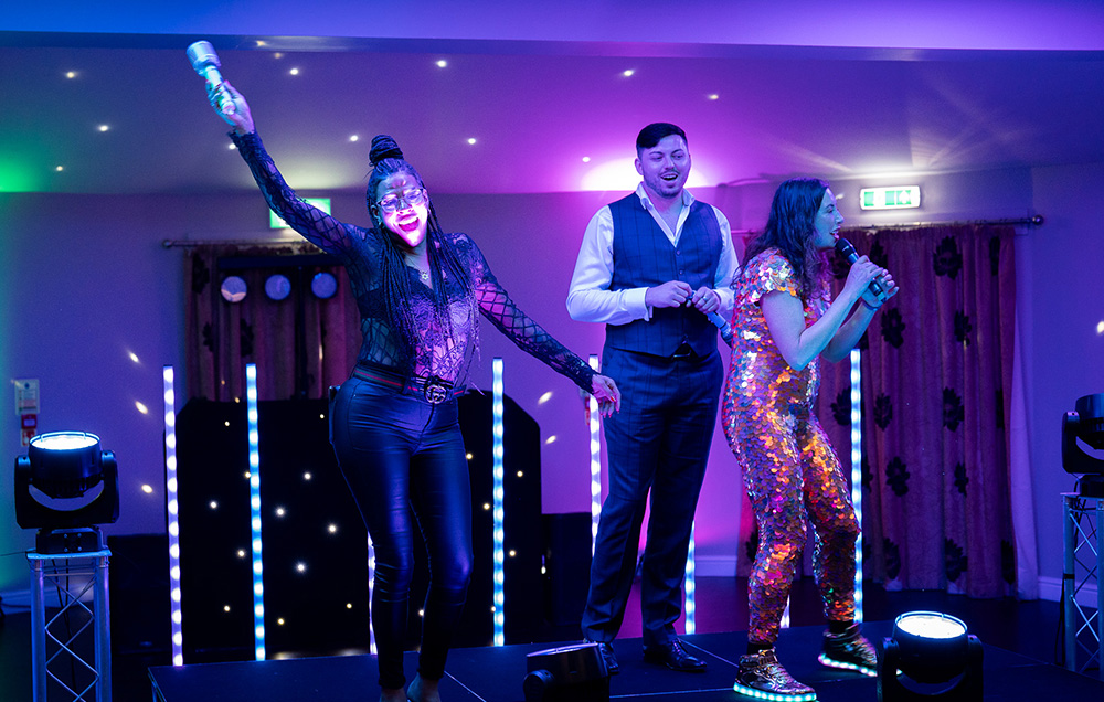 People on brightly lit purple stage