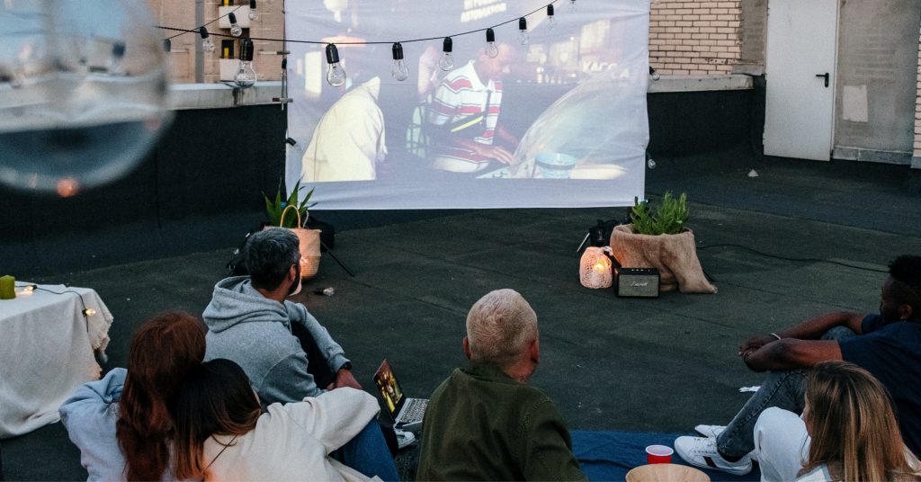people watching an outdoor theatre
