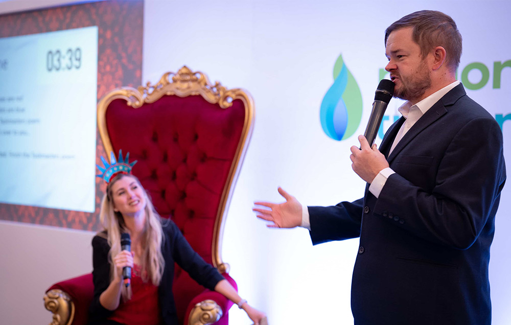 One presenter sat down and other stood on stage