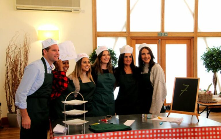 Team smiling at charity bake off