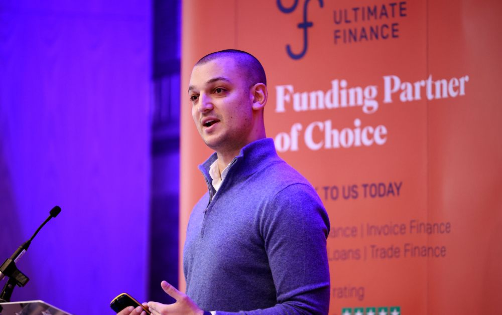 Man speaking on stage at conference