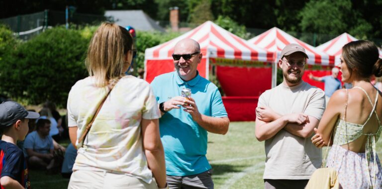 people laughing near fate stalls