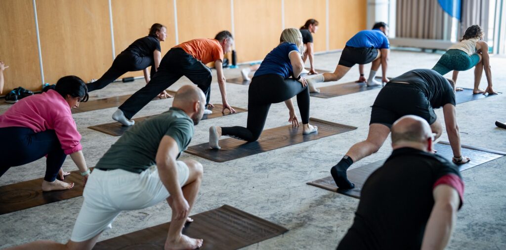 People ding yoga at conference venue