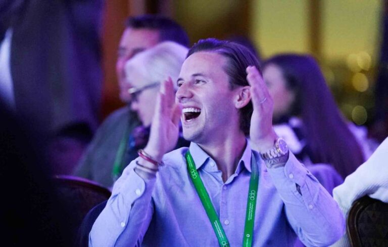 Man cheering with lanyard on