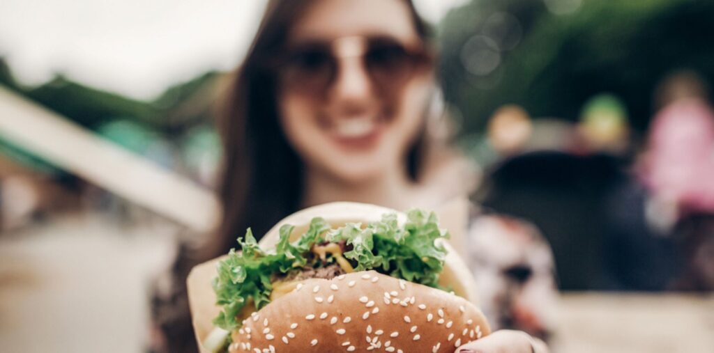 Girl eating plant based burger