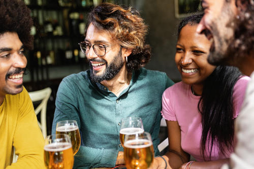Happy multiracial business colleagues having a drink after completing a corporate treasure hunt